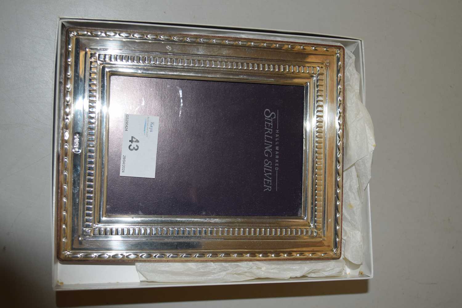 A small modern silver mounted easel back photo frame