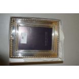 A small modern silver mounted easel back photo frame
