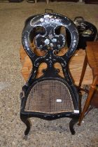 A Victorian mother of pearl and papier mache bedroom chair with cane seat