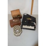 A child's toy piano together with three small boxes, one containing assorted coinage