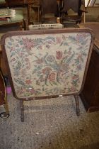 A fabric covered combination fire screen or folding occasional table