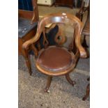 A late 19th or early 20th Century bow back revolving desk chair
