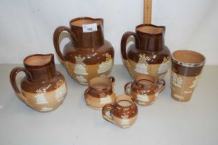 A group of Doulton stone ware jugs and cruet items with sprigged harvest and hunting scene