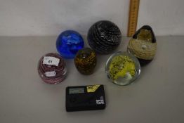 Collection of paperweights and a guitar tuner