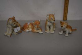 A group of Russian porcelain model lion and leopard cubs