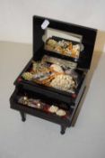 A small piano shaped jewellery box containing various costume jewellery