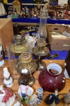 A group of three metal based oil lamps plus a further small glass based oil lamp (4)
