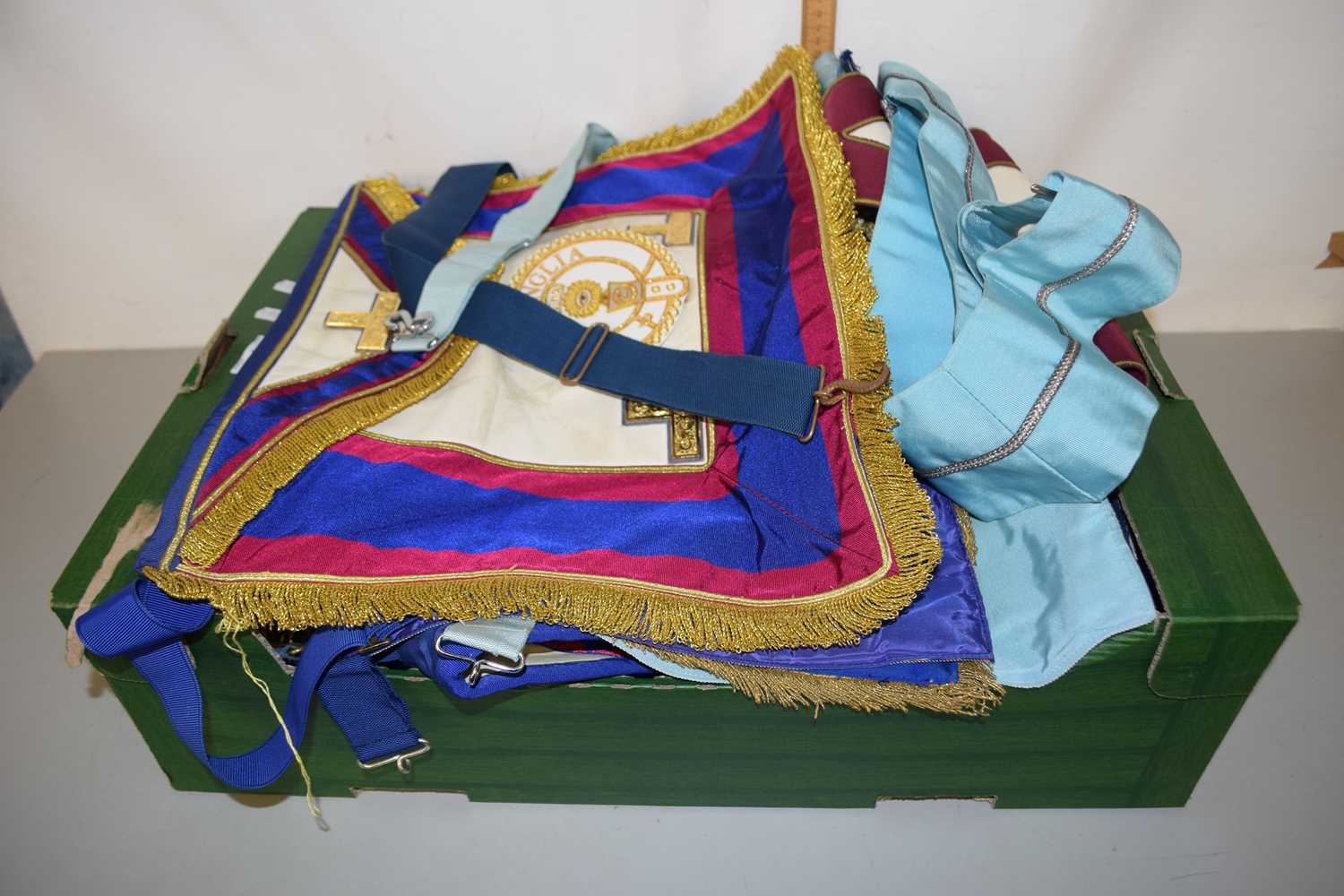 A box of various Masonic sashes