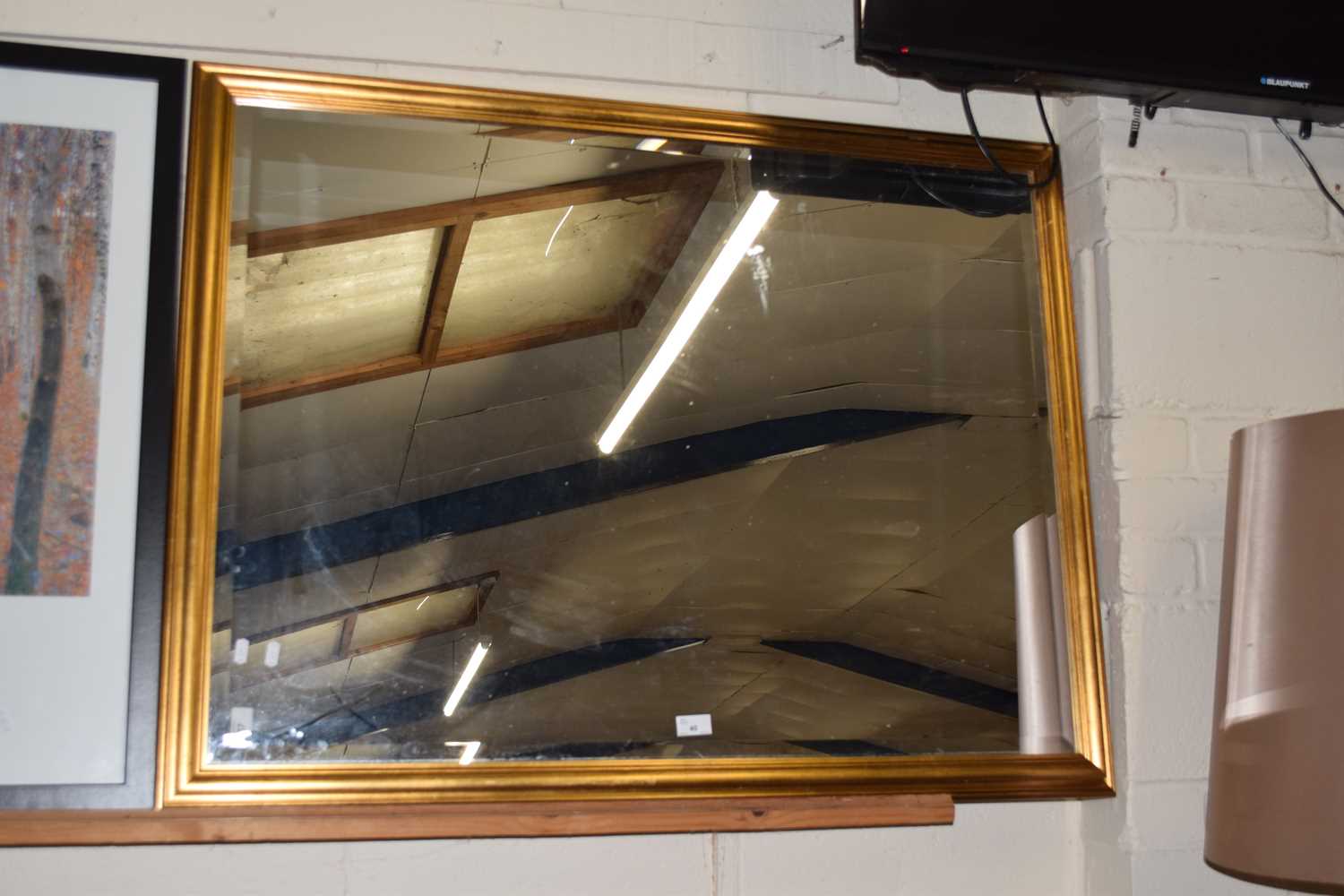 A large gilt framed bevelled wall mirror