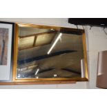 A large gilt framed bevelled wall mirror