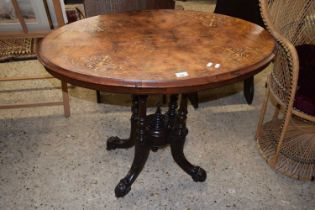 A Victorian walnut veneered centre table with oval top and four outswept legs, 90cm wide