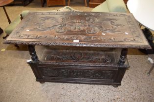 A late Victorian gothic oak monks bench, 107cm wide