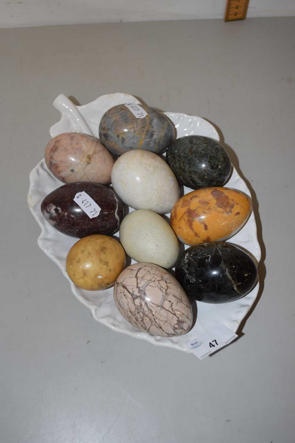 A collection of various polished stone eggs