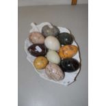 A collection of various polished stone eggs