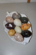 A collection of various polished stone eggs