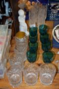 A group of various drinking glasses to include turquoise wine glasses, clear glass tumblers and