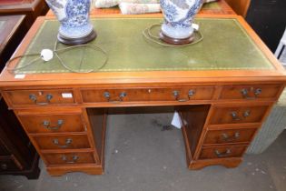 A modern yew wood veneered twin pedestal office desk, 123cm wide