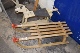 Vintage sledge and a child's wooden wheeled horse