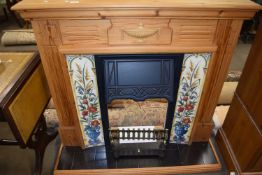 A pine and tile finish fire surround