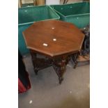 A late Victorian American walnut octagonal centre table