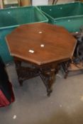 A late Victorian American walnut octagonal centre table