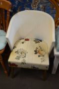 A retro Lloyd Loom type chair with rose upholstered seat