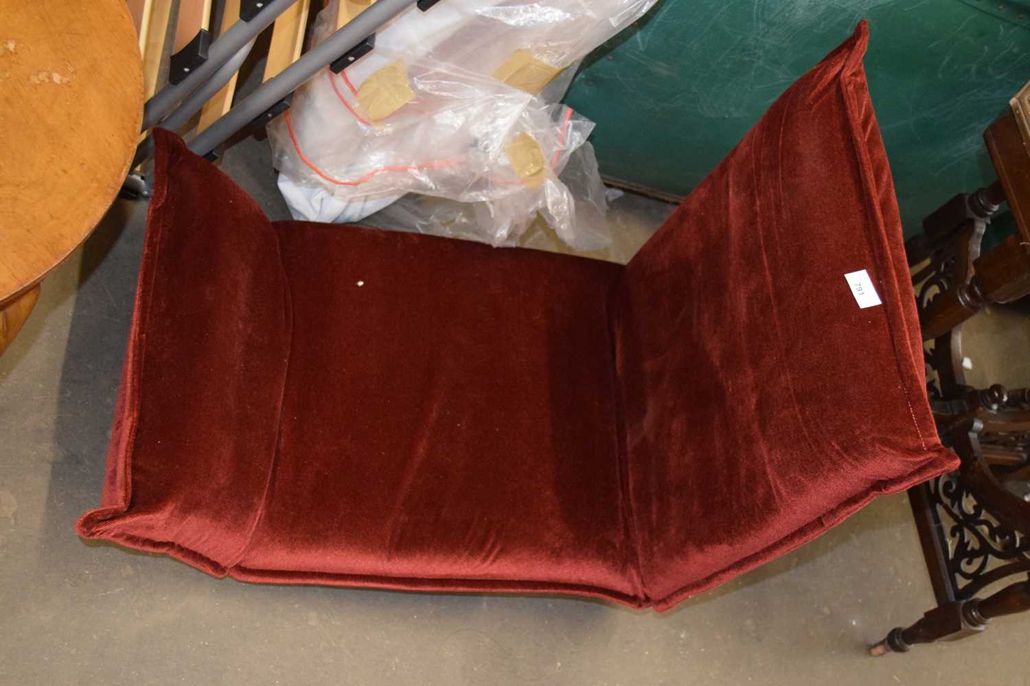 A folding red upholstered recliner