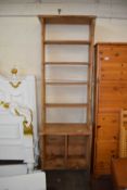 A small pine narrow bookcase