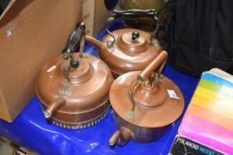 A group of three vintage copper kettles