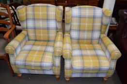 A pair of armchairs with tartan style fabric