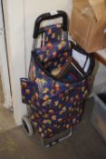 A shopping trolley filled with various assorted pictures and picture frames