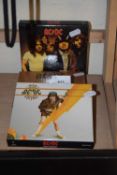 A group of three ACDC CD's