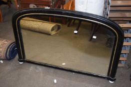 A Victorian small over mantel mirror in ebonised arched frame