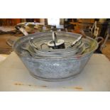 Four galvanised tubs together with a galvanised watering can