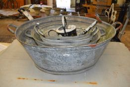 Four galvanised tubs together with a galvanised watering can