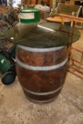 An oak barrel with a glass top