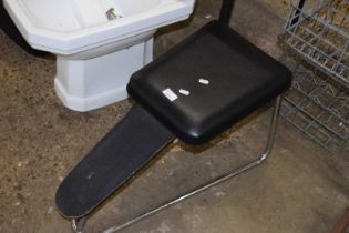 A chrome shoe fitting stool