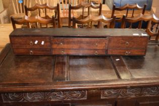 A small 19th Century six drawer cabinet, probably part of a larger piece, 94cm wide