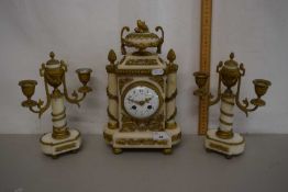 A clock garniture with alabster and gilt decoration in French Empire style, the dial with Roman