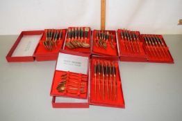 A collection of solid bronze cutlery from Thailand in original boxes