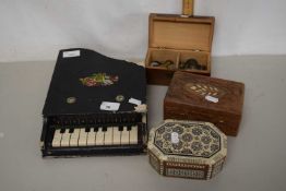 A small box with inlaid diamond motif containing a quantity of coinage together with a small piano