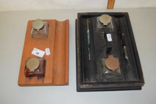 A wooden ink stand with two bottles together with a further ink stand