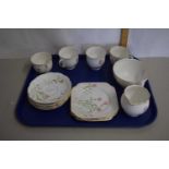 An English porcelain tea service comprising cups, saucers, side plates and tray