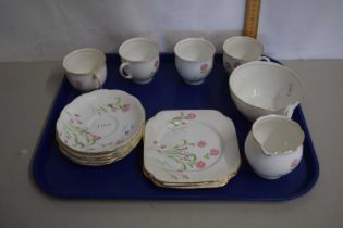 An English porcelain tea service comprising cups, saucers, side plates and tray