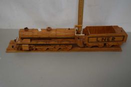A wooden model of a steam engine with tender, the tender marked LNER
