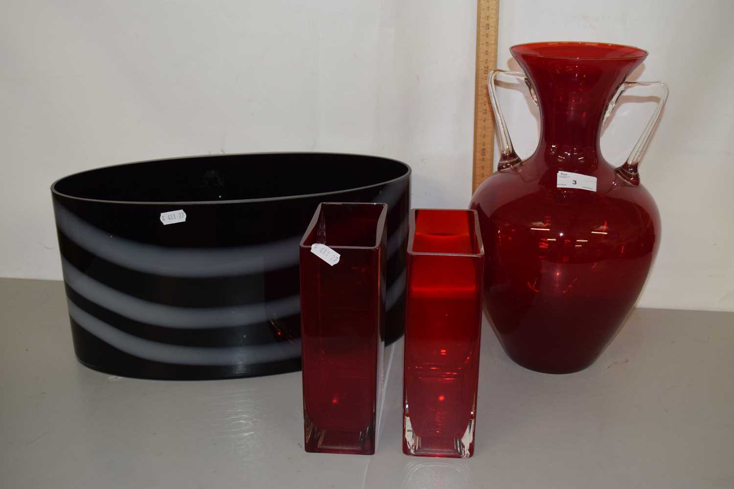 Two rectangular shaped ruby red glass vases together with a large amphora type glass vase, largest