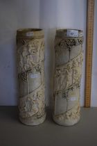 A pair of cylindrical pottery vases with relief design of children, 37cm high