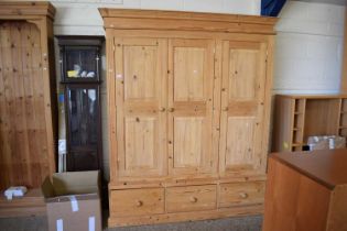 A waxed pine triple wardrobe, width approx 154cm