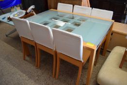 A good quality modern glass topped dining table together with a set of six upholstered chairs