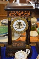 Victorian mantel clock supported with Corinthian columns with inlaid scrolling design